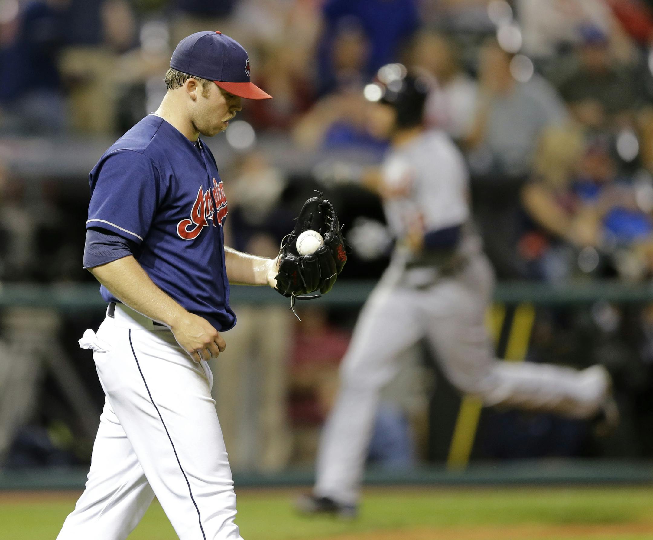 Cleveland Indians relief pitcher Cody Allen, left, waits for Detroit Tigers' J.D. Martinez, right, to run the bases after Martinez hit a three-run home run in the ninth inning of a baseball game, Tuesday, Sept. 2, 2014, in Cleveland. Torii Hunter and Steven Moya scored on the play. The Tigers defeated the Indians 4-2. (AP Photo/Tony Dejak)