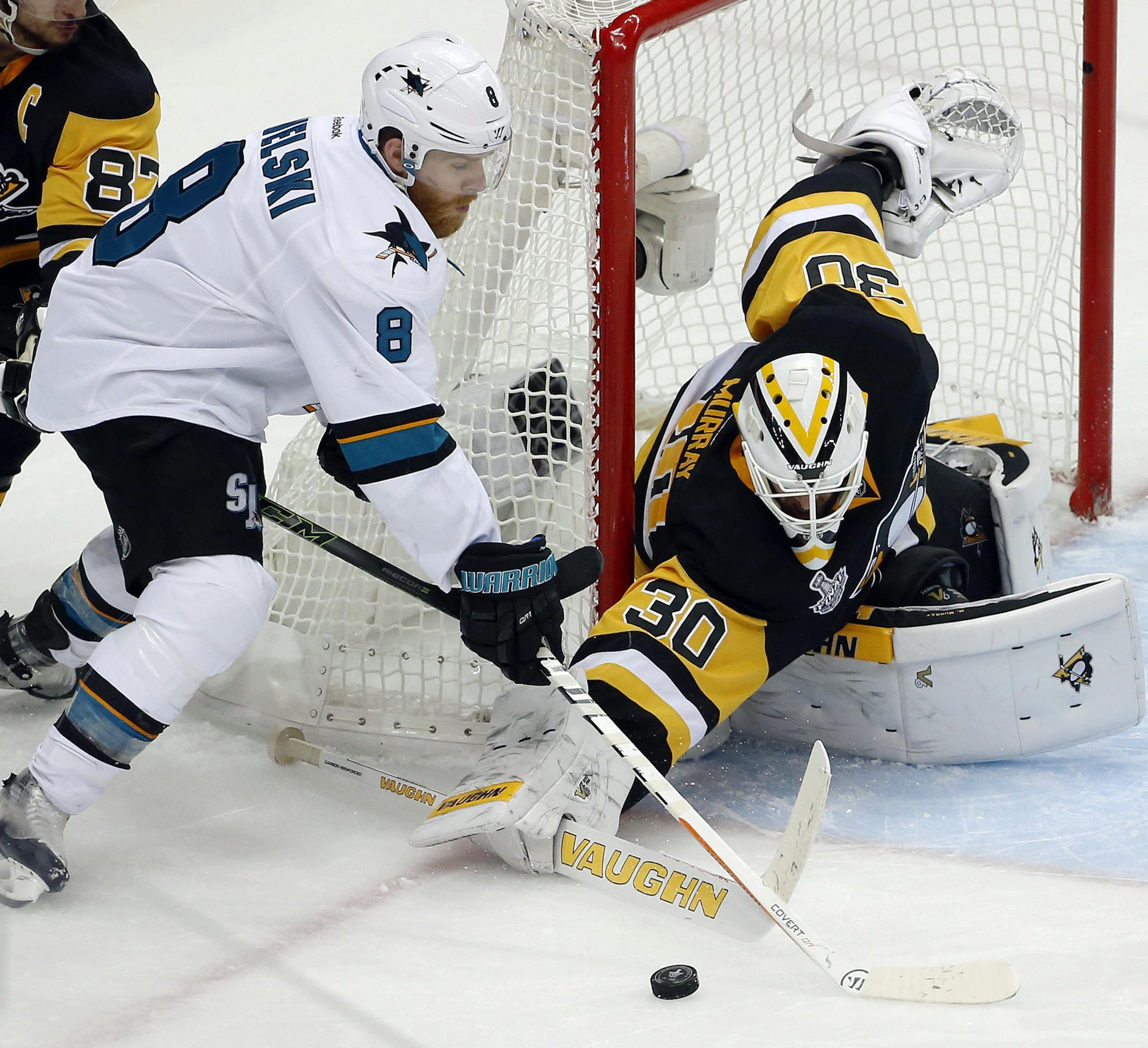 Pittsburgh Penguins goalie Matt Murray (30) pokes the puck away from San Jose Sharks' Joe Pavelski (8) during the third period in Game 2 of the NHL hockey Stanley Cup Finals on Wednesday, June 1, 2016, in Pittsburgh. (AP Photo/Gene J. Puskar)