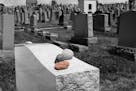 iStock
Scene at a Jewish cemetery with focus on red stone placed on headstone.