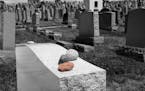 iStock
Scene at a Jewish cemetery with focus on red stone placed on headstone.