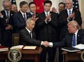 President Donald Trump and Vice Premier Liu He of China shake hands after signing a limited trade agreement at the White House on Wednesday, Jan. 15, 