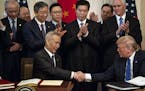 President Donald Trump and Vice Premier Liu He of China shake hands after signing a limited trade agreement at the White House on Wednesday, Jan. 15, 