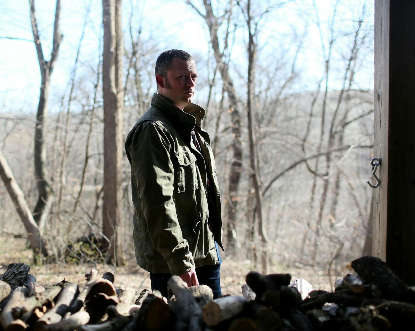 Author and St. Olaf College writer-in-residence Benjamin Percy outside his Northfield home. In his scant spare time, he likes to cut and split firewood.