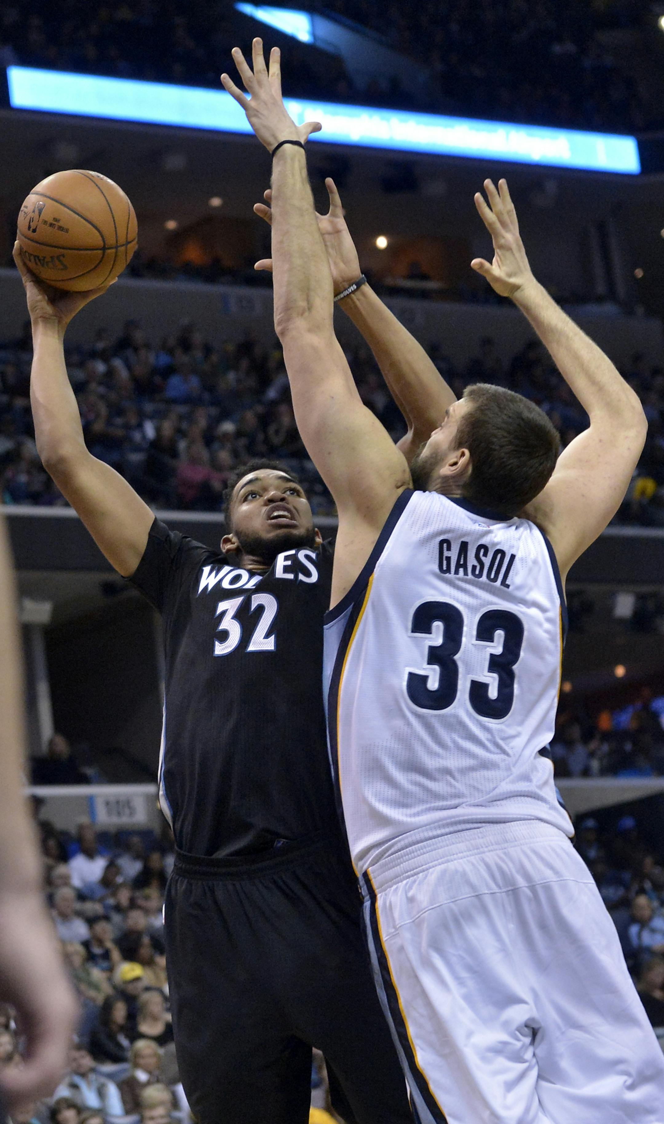 Minnesota Timberwolves center Karl-Anthony Towns (32) shoots against Memphis Grizzlies center Marc Gasol (33) in the first half of an NBA basketball game Saturday, Nov. 19, 2016, in Memphis, Tenn. (AP Photo/Brandon Dill)