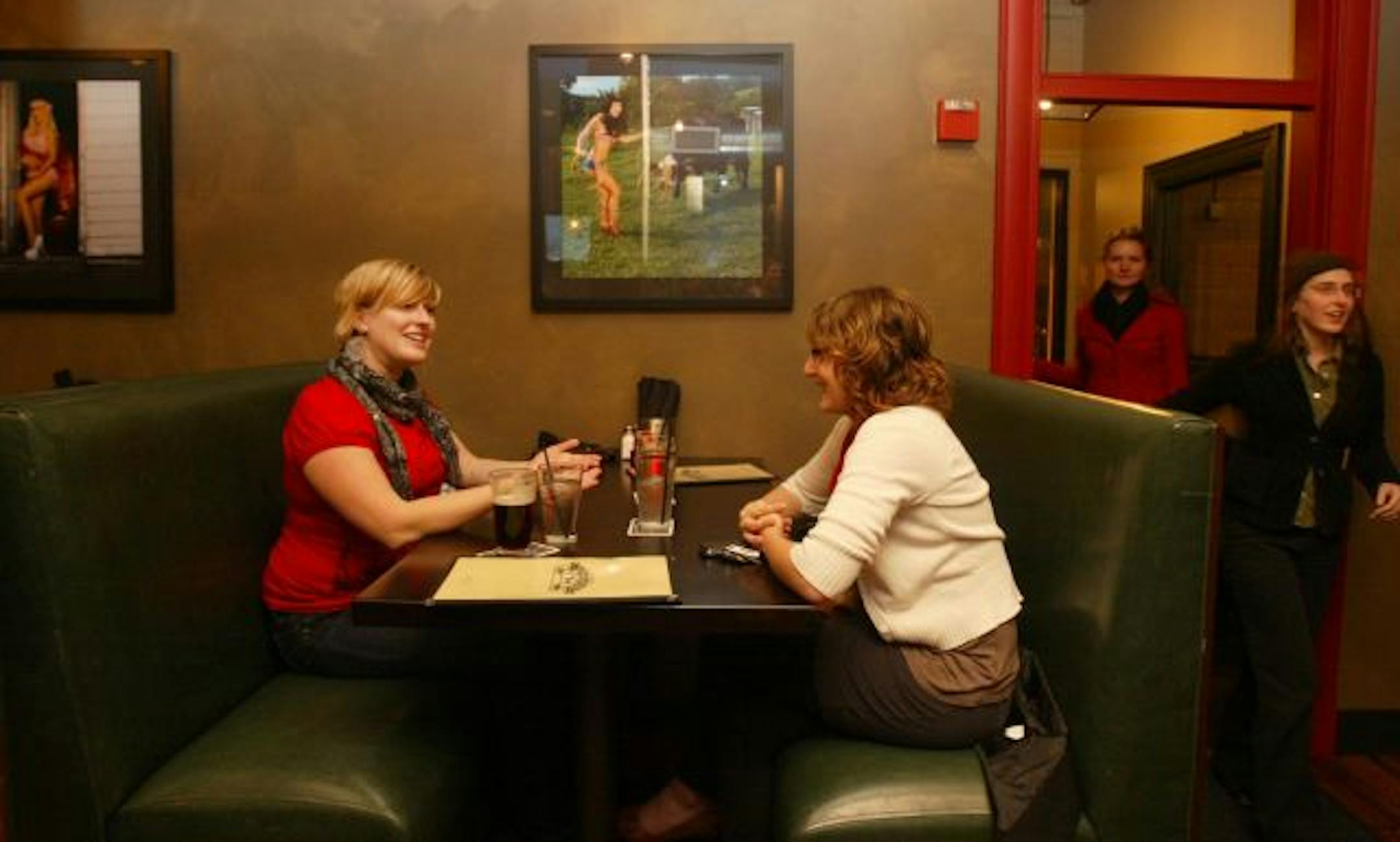 Katie Roth, left, Minneapolis, and Eve Thomas of Minneapolis, have an appetizer and drinks at the Lyndale Tap House in Uptown.