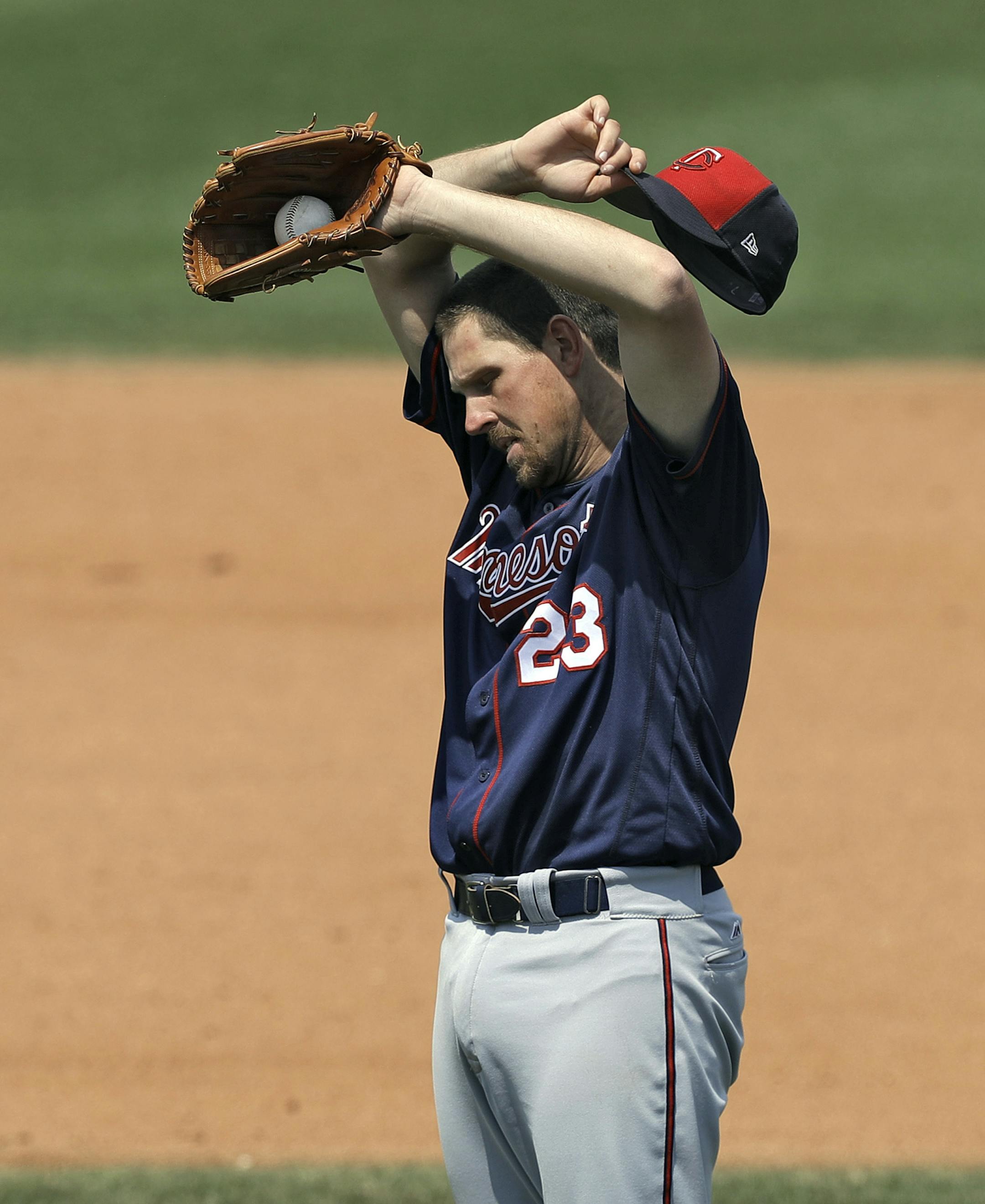 Minnesota Twins pitcher Nick Tepesch wipes his forehead as he works against the Philadelphia Phillies during the fifth inning of a spring training baseball game Thursday, March 23, 2017, in Clearwater, Fla. (AP Photo/Chris O'Meara)