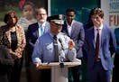 Minneapolis police chief Medaria Arradondo, at podium, and Minneapolis Mayor Jacob Frey, right, joined other city leaders in announcing a new model fo