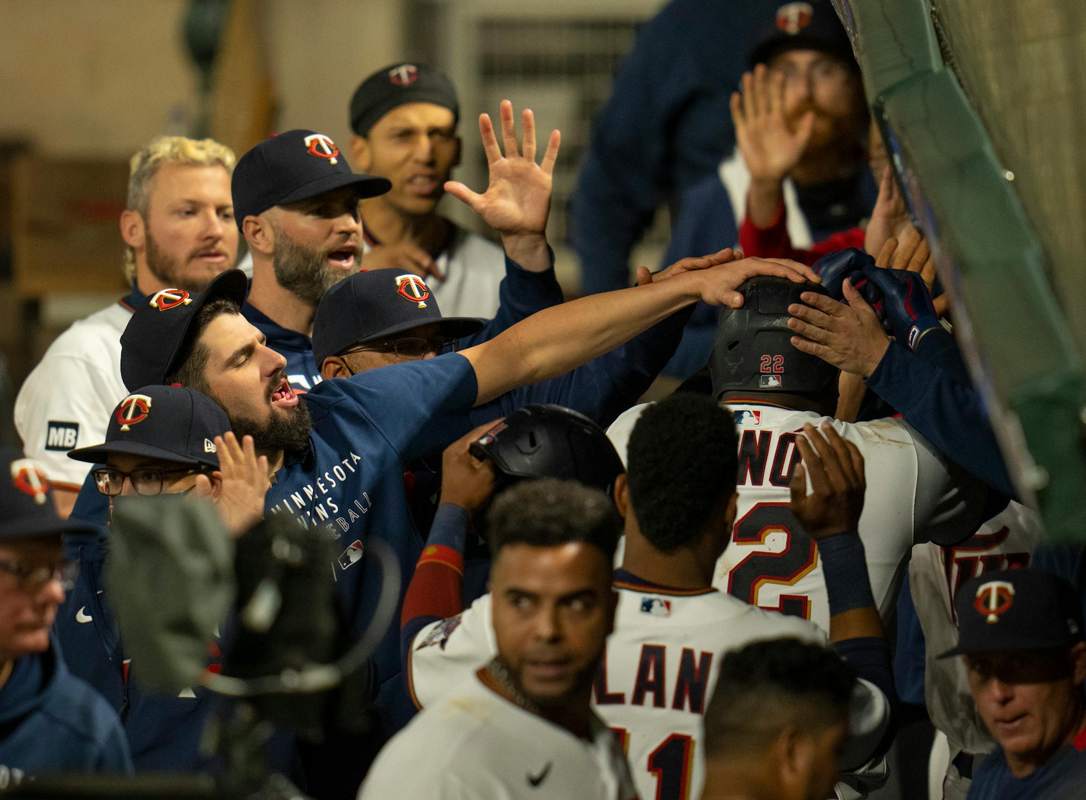 Minnesota Twins first baseman Miguel Sano (22) was congratulated in the dugout after his third home run of the game in the eighth inning that scored Jorge Polanco and tied the game 4-4.