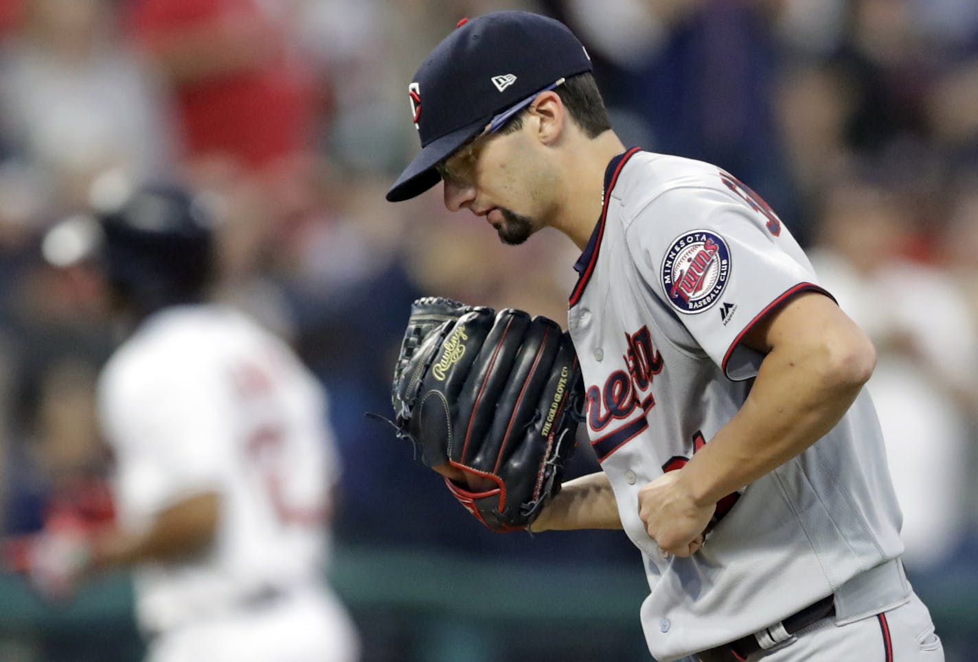 Minnesota Twins starting pitcher Devin Smeltzer, right, waits for Cleveland Indians' Francisco Lindor to run the bases after Lindor hit a two-run home run in the fifth inning of a baseball game, Tuesday, June 4, 2019, in Cleveland. Leonys Martin scored on the play. (AP Photo/Tony Dejak)