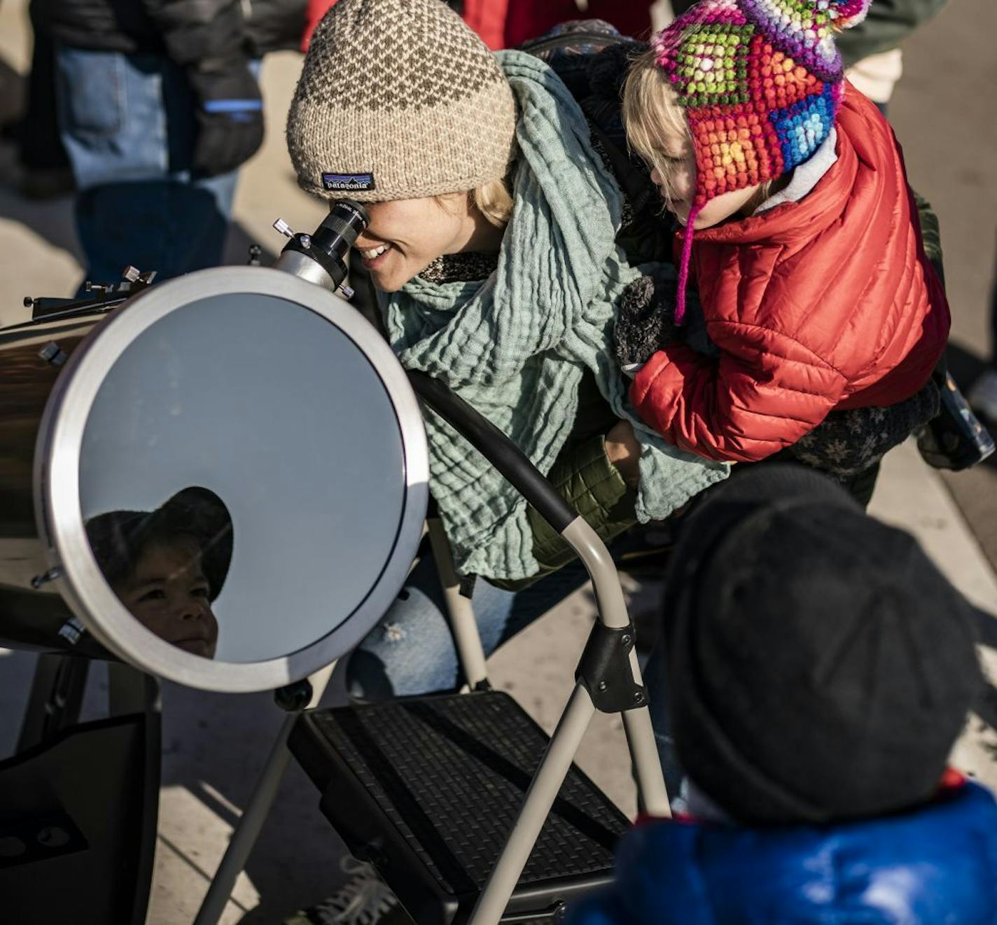 Erin Armijo He used one of the Bell Museum's telescopes to watch Mercury's transit across the sun on Monday, Nov. 11. She was holding daughter Birdie, 2, after Anderson,4, had his turn.