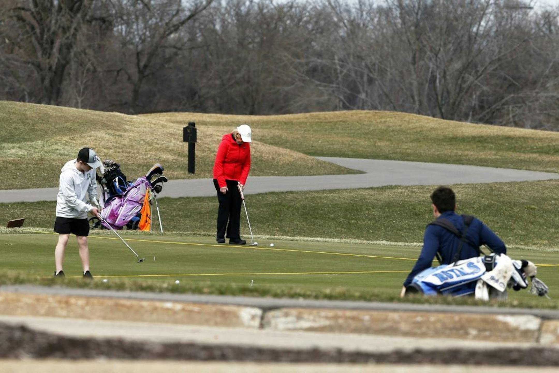 Golfers practice putting at Braemar Golf Course in Edina.