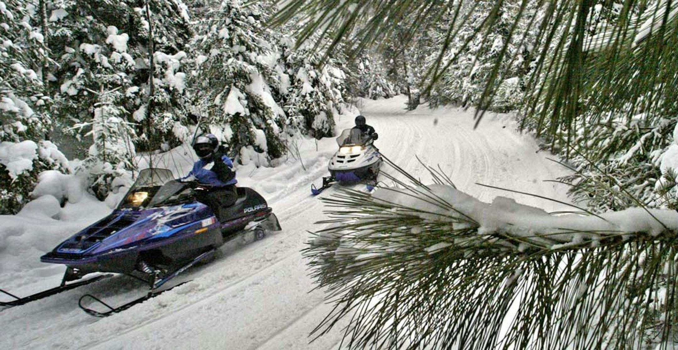 Marlin Levison - Strib 01/29/05 - Assign #93821 - Hundreds of snowmobilers headed to Ely over the weekend to participate in annual Fun Run snowmobile tour following state trails to Babbitt and Tower as well as Ely. Several thousand dollars of cash prizes were awarded to drivers with proceeds of the event to go towards maintaining the area snowmobile trails. Viking mascot Ragnar hosted the drivers. Over 500 sleds were registered to run the 150 mile loop. - IN THIS PHOTO: Sledders head down the Ta