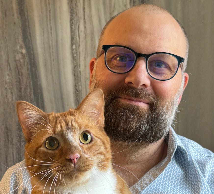 photo of author Jonathan C. Slaght, with a cat