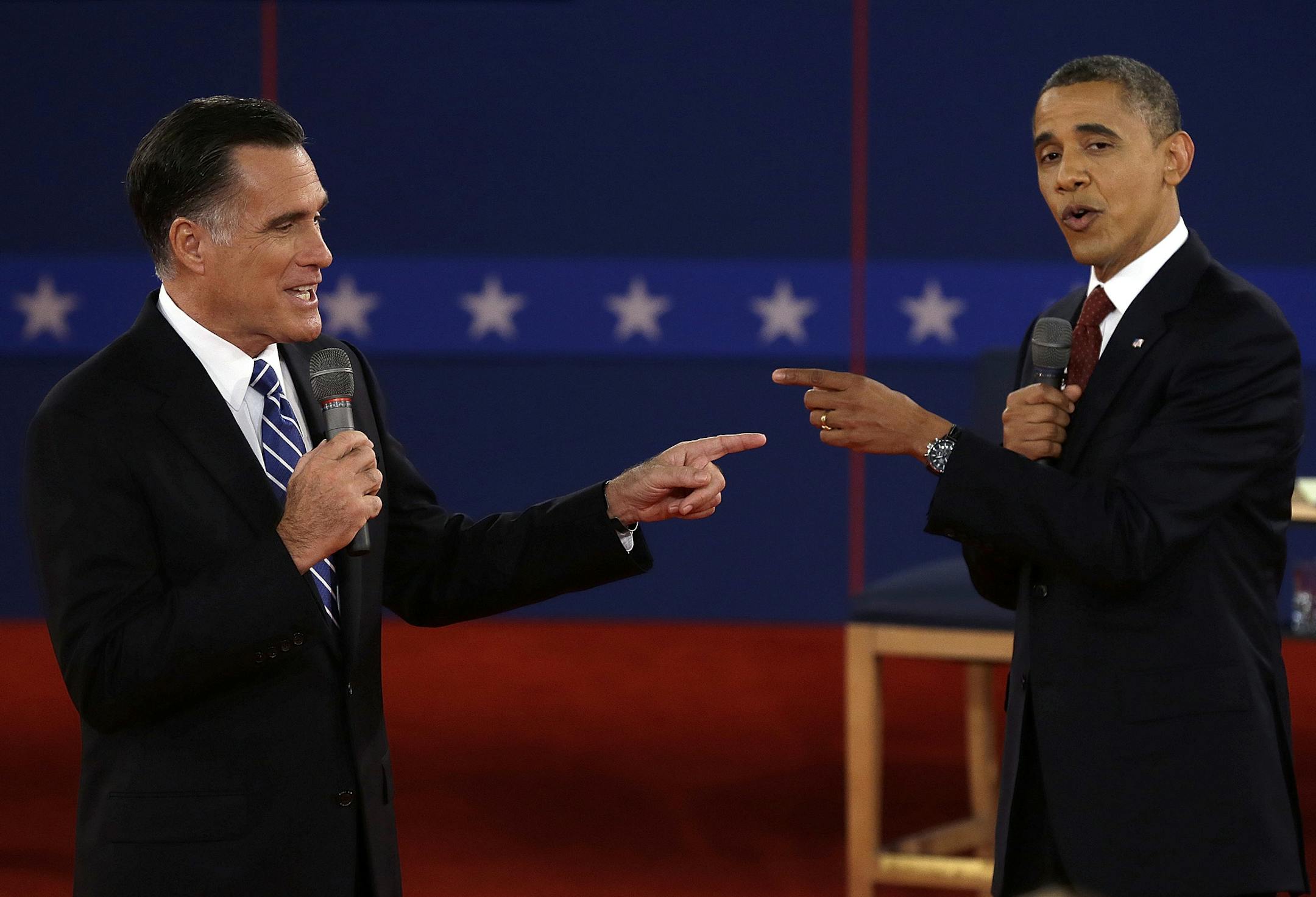 FILE - In this Oct. 16, 2012 file photo, Republican presidential nominee Mitt Romney, left, and President Barack Obama spar during the second presidential debate at Hofstra University in Hempstead, N.Y. For presidential candidates, the town hall debate is a test of stagecraft as much as substance. When Hillary Clinton and Donald Trump meet in the Sunday, Oct.9, 2016, contest, they&#x2019;ll be fielding questions from undecided voters seated nearby. In an added dose of unpredictability, the forma