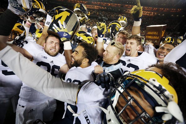 Michigan celebrated with the Little Brown Jug after beating Minnesota 29-26 at TCF Bank Stadium Saturday October 31, 2015 in Minneapolis