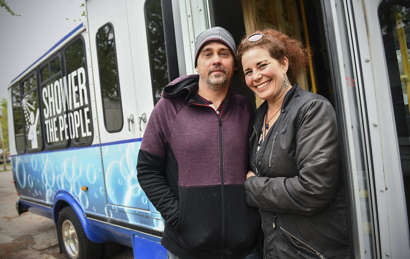 Jason Jaques and Nancy Dyson stand next to their mobile shower van they will operate as part of their nonprofit, Neighbors to Friends, during an interview Saturday, May 18, 2019, in Sauk Rapids, Minn. (Dave Schwarz/The St. Cloud Times via AP)