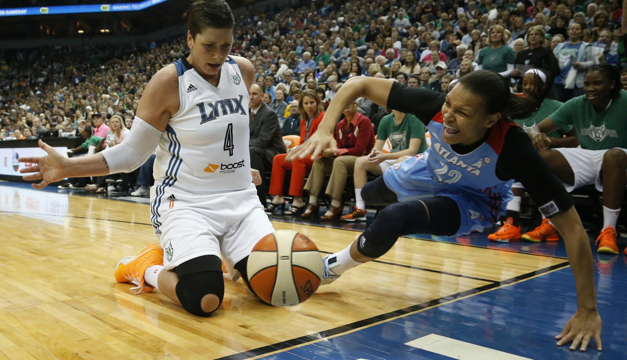 Lynx Janel McCarville and the Dream's Armintie Herrington tried to not touch the ball as it rolled out of bounds during the first quarter of the WNBA Finals at the Target Center in Minneapolis, Min., Sunday, October 6, 2013