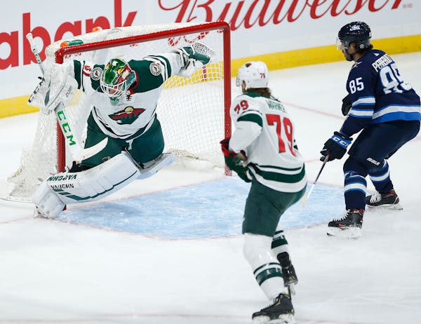 Wild goaltender Kaapo Kahkonen saved this shot from Winnipeg's Mathieu Perreault during the first period but by then the Jets already had a 2-0 lead.