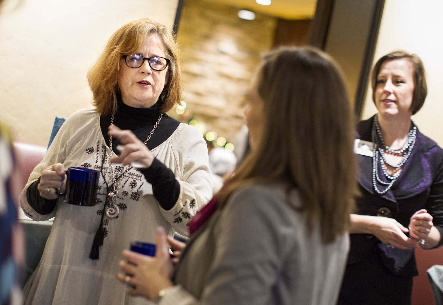 Kelly Pratt, left, of Creative Catalyst Studio, chats with fellow members of Women in Networking (WIN) during a monthly breakfast networking event at the Downtowner Woodfire Grill in St. Paul December 8, 2015. (Courtney Perry/Special to the Star Tribune)