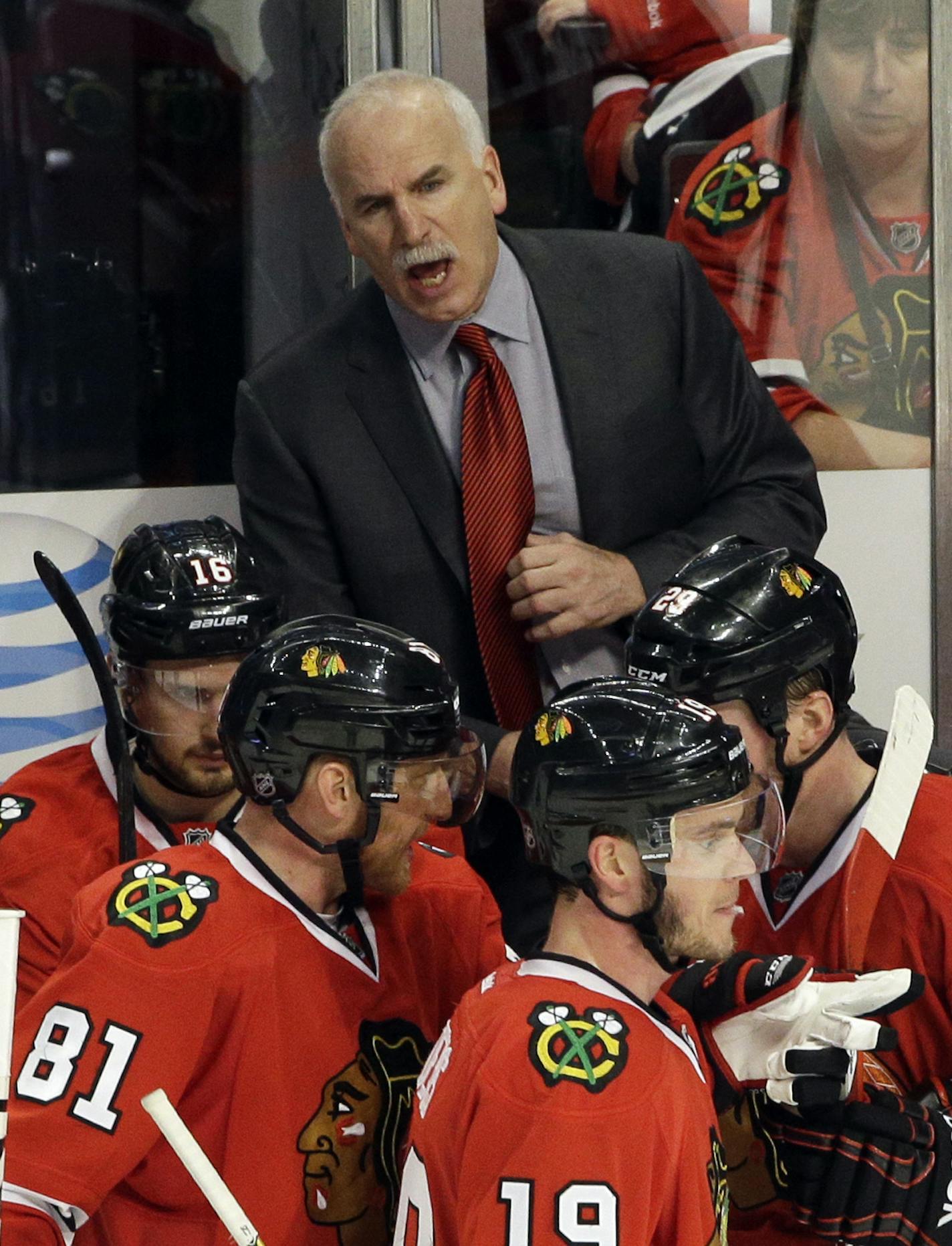 Chicago Blackhawks head coach Joel Quenneville, top, talks to his team during the third period in Game 1 of an NHL hockey second-round playoff series against the Minnesota Wild in Chicago, Friday, May 2, 2014. The Blackhawks won 5-2. (AP Photo/Nam Y. Huh)