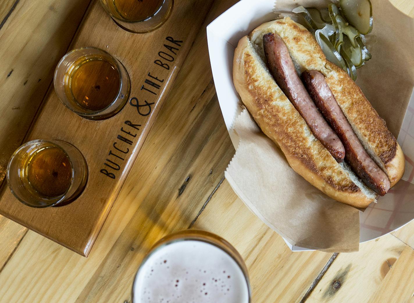 The Butcher and the Boar's beer, brat and a shot. ] BRIDGET BENNETT SPECIAL TO THE STAR TRIBUNE &#x2022; bridget.bennett@startibune.com Combination is sold for $12 in their beer garden. Only one shot is provided in the bcomo, didn't want the three shots to be misleading.