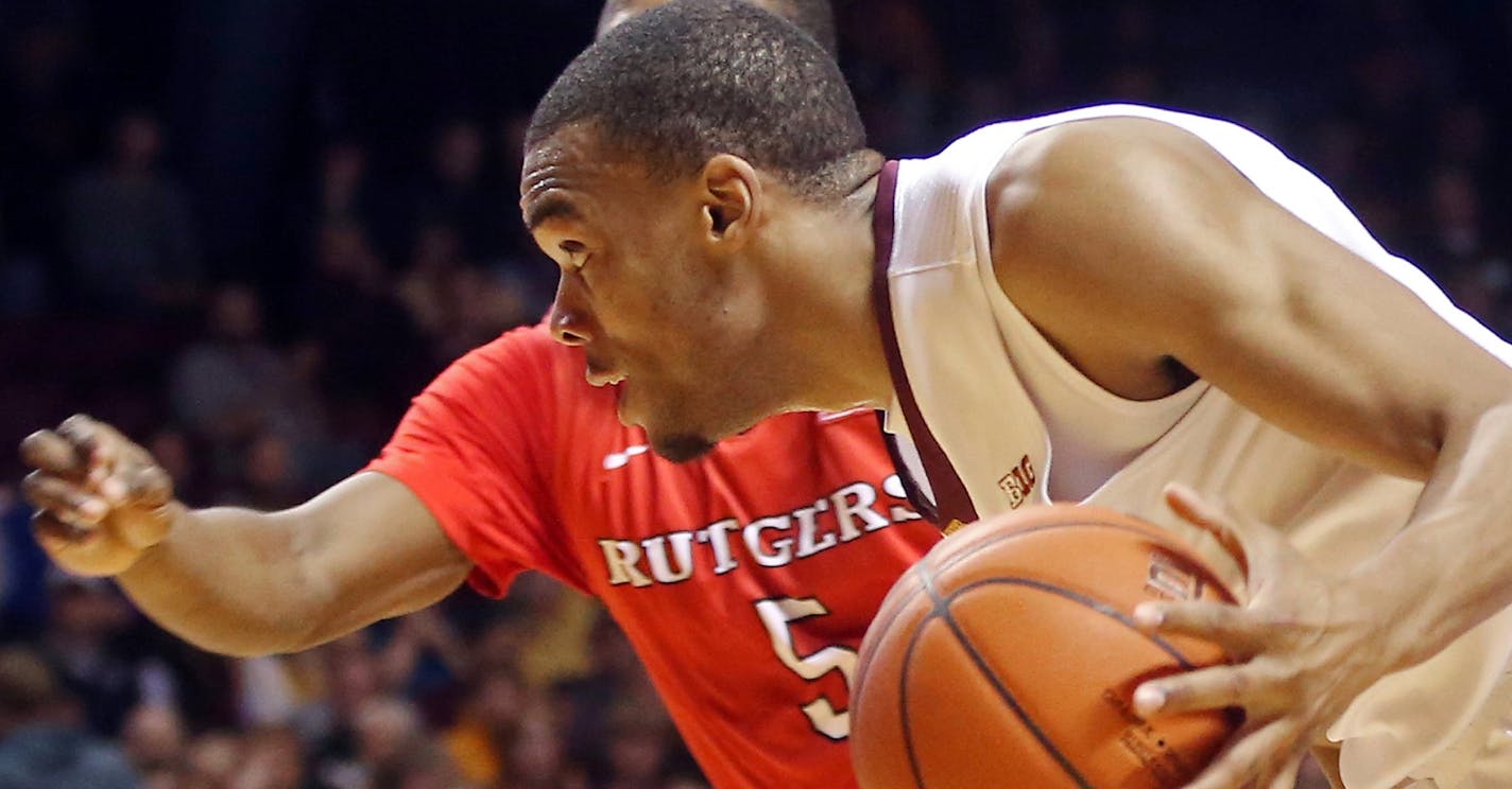 Minnesota&#x2019;s Andre Hollins, right, drives around Rutgers&#x2019;s Mike Williams in the second half of an NCAA college basketball game, Saturday, Jan. 17, 2015, in Minneapolis. Hollins led Minnesota with 31 points in their 89-80 win. (AP Photo/Jim Mone)