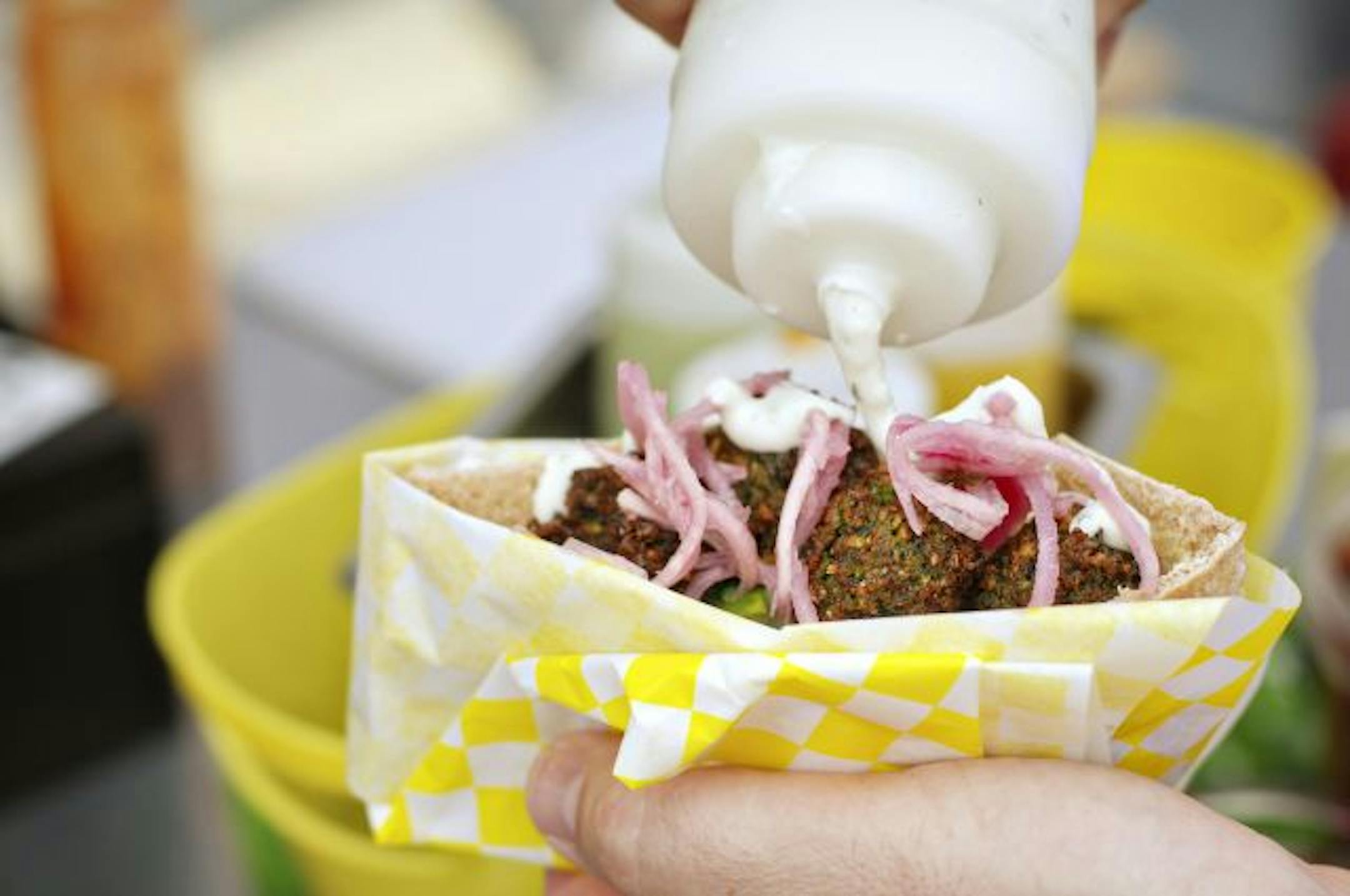 Cucumber mint sauce tops the falafel sandwiches by Foxy Falafel.
