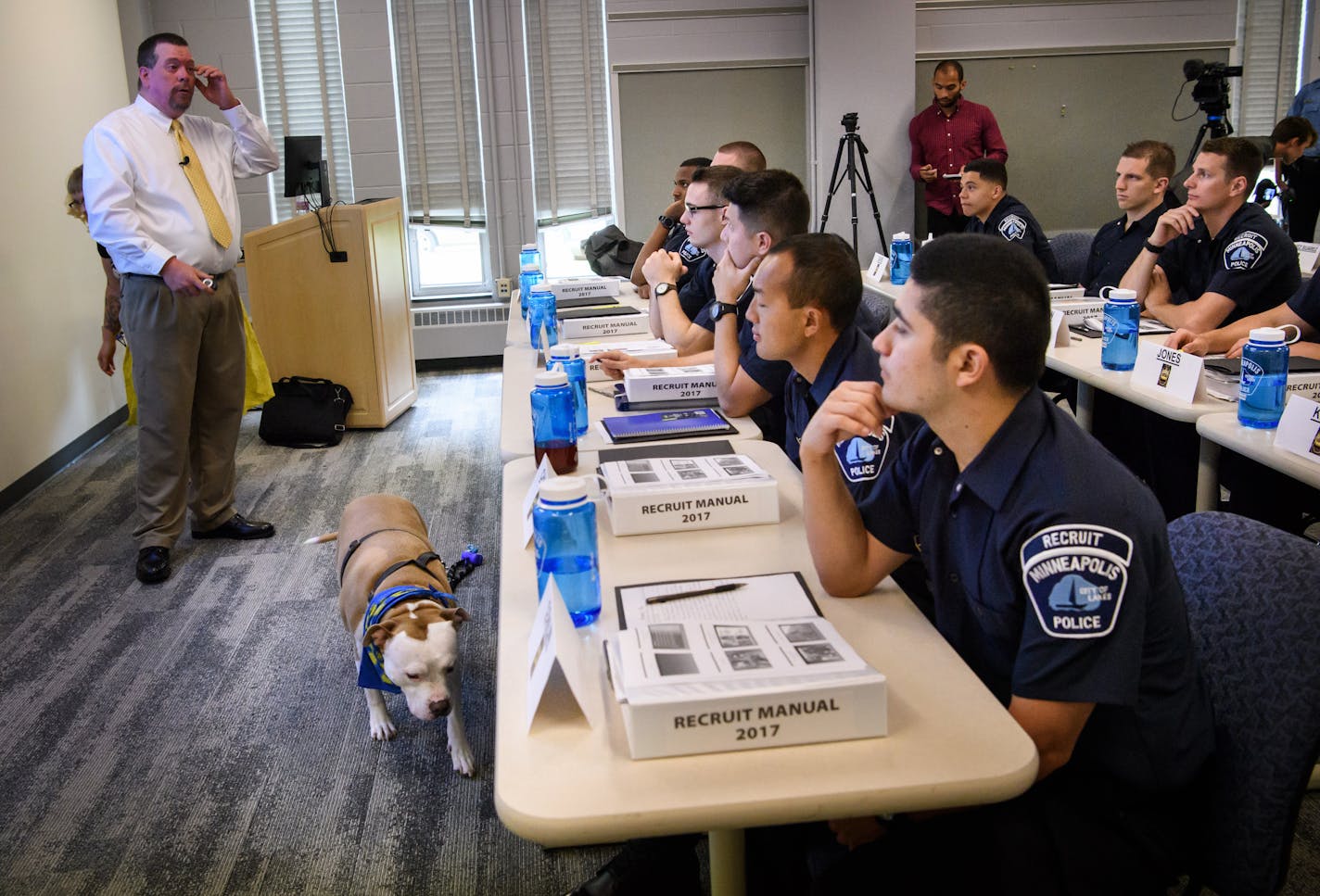 Minneapolis police recruits listened as J. Scott Hill, chief Investigator for Montgomery Alabma's humane officer division, talked about how to know if a dog is a threat. As he spoke, Wilbur, a 6-year-old pit bull type dog walked through the class. Wilbur was there with Shannon Glen who also trains groups on dog safety. ] GLEN STUBBE � glen.stubbe@startribune.com Monday August 21, 2017 Minneapolis police recruits will meet with dog trainer and national leader of "My Pitbull is Family" Monday, par