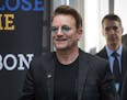 FILE - In this Sept. 17, 2016 file photo, Bono arrives at the Global Fund conference in Montreal. Bono will be honored as Glamour magazine's first Man