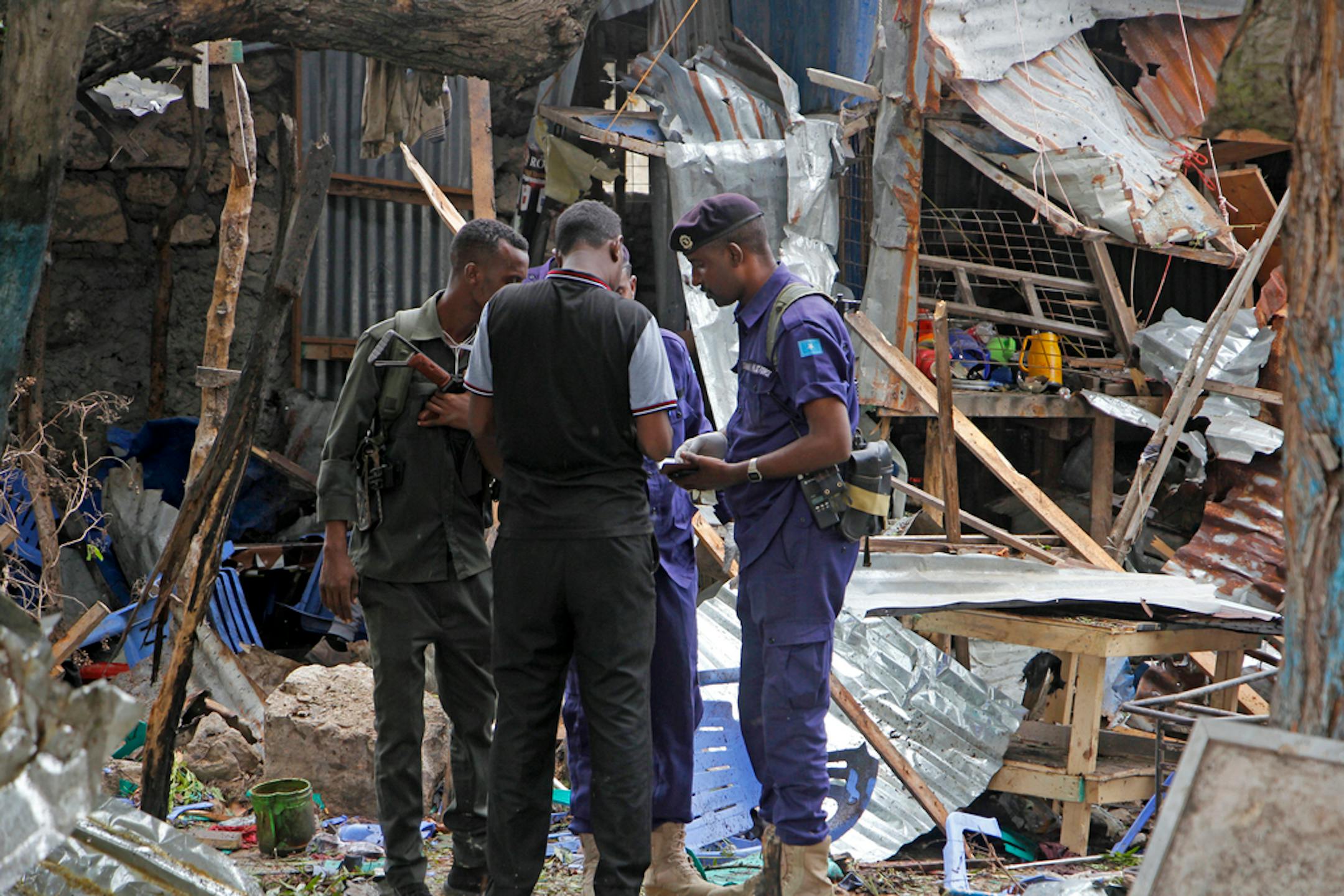 Security forces gather in the remains of destroyed houses after a suicide bomb attack in Mogadishu, Somalia Tuesday, Nov. 17, 2020.