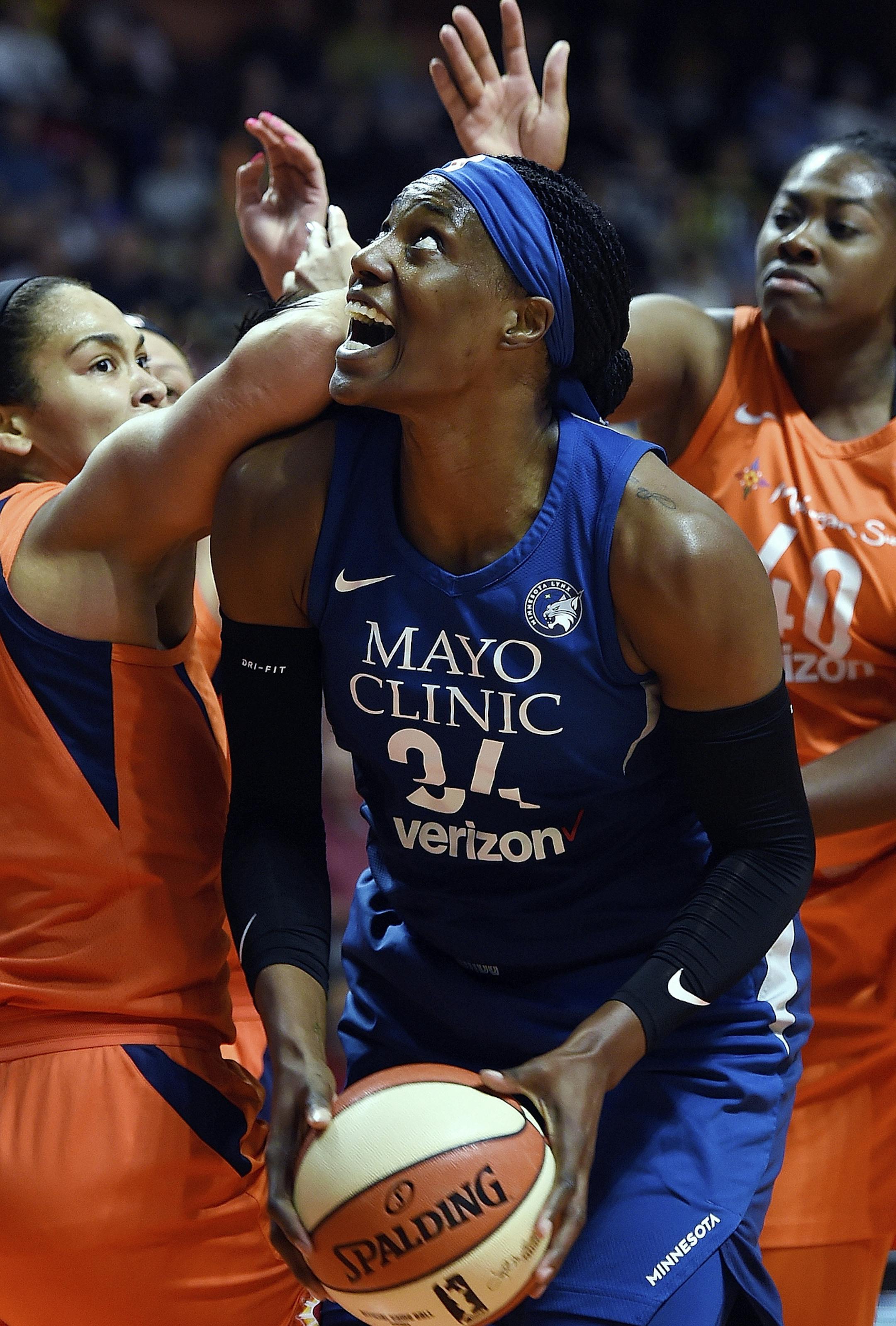 Minnesota Lynx center Sylvia Fowles (34) battles the defense of Connecticut Sun center Brionna Jones (42) and forward Shekinna Stricklen during the second half of a WNBA basketball game Friday, Aug. 17, 2018, in Uncasville, Conn. (Sean D. Elliot/The Day via AP)
