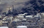 FILE - In this April 26, 2018, file frame from video smoke rises from the Husky Energy oil refinery after an explosion and fire at the plant in Superi