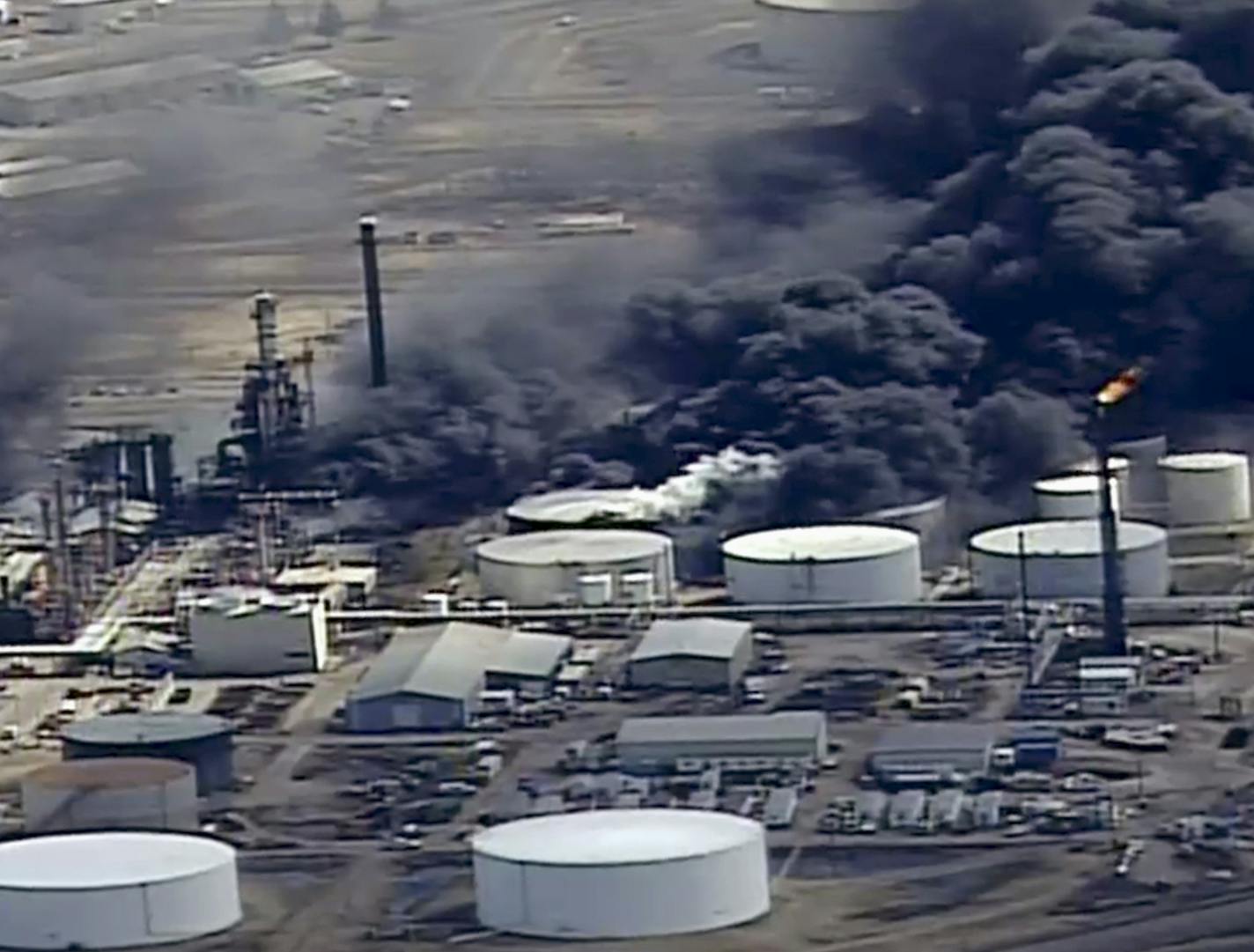 FILE - In this April 26, 2018, file frame from video smoke rises from the Husky Energy oil refinery after an explosion and fire at the plant in Superior, Wis. The mayors of the Lake Superior twin port cities near last week's explosion and fire are calling on its owners to stop using a dangerous chemical compound at the site. Husky Energy is one of about 50 refineries in the country that still uses hydrogen fluoride to process high-octane gasoline. (KSTP-TV via AP, File)