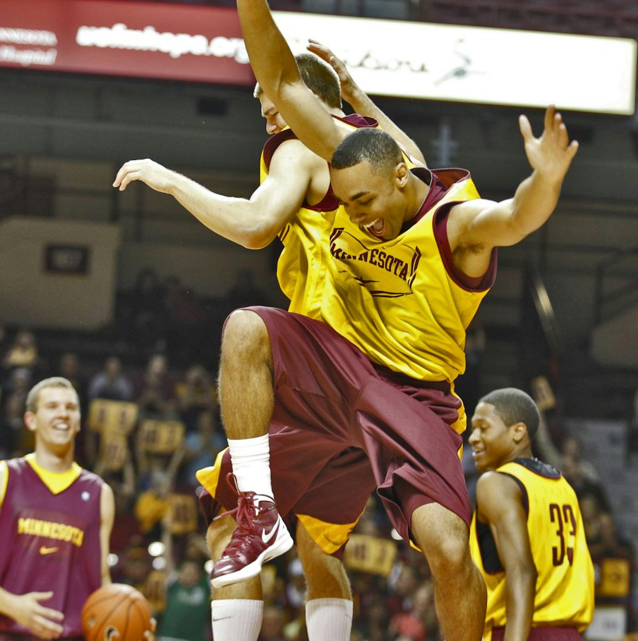 UM Gophers basketball team opened their season with a skills and scrimmage session Friday night. Joe Coleman, foreground celebrated with teammates after winning the dunk contest.