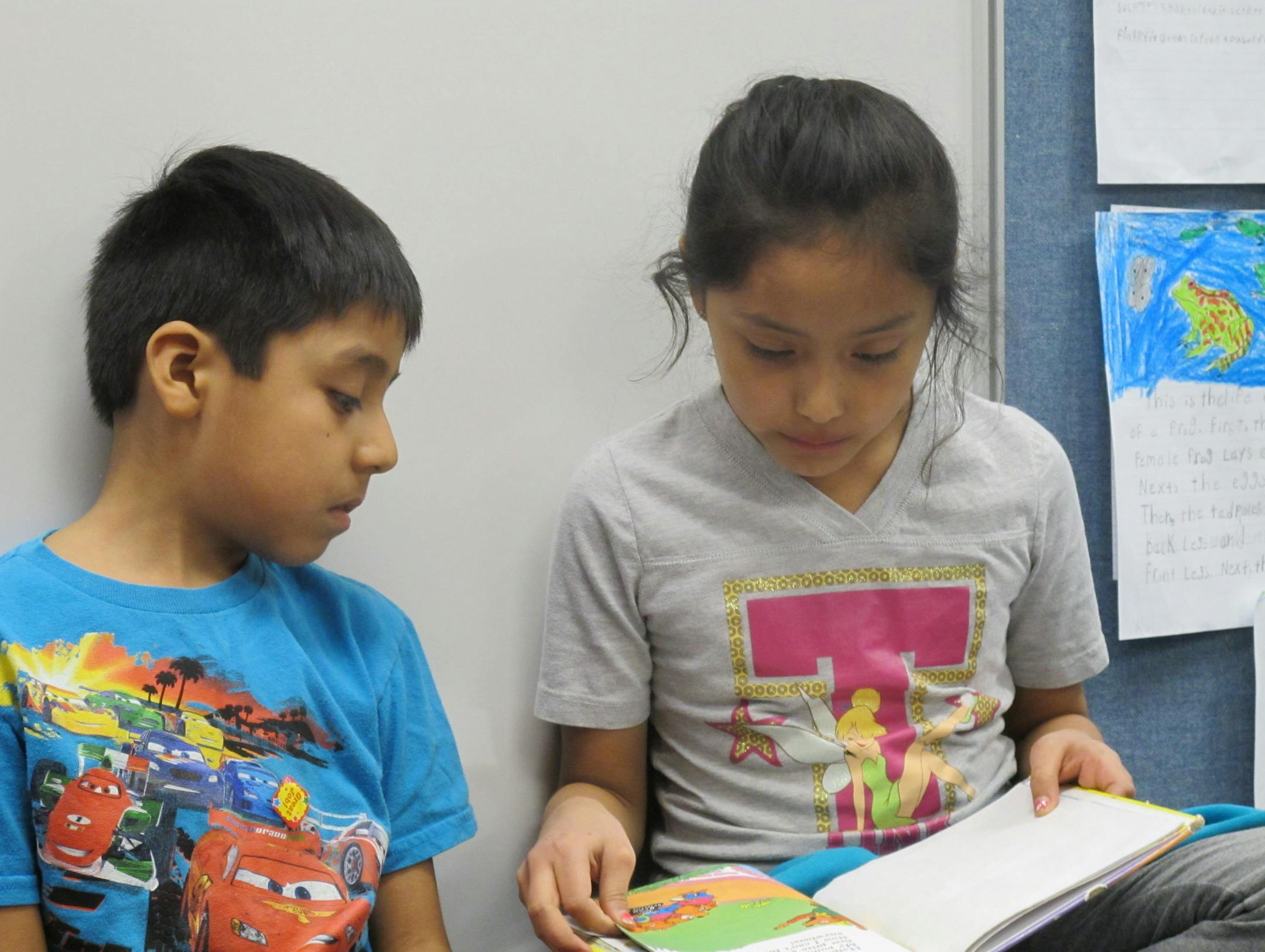 Photo by Erin Adler Third-grader Dayana Estrada Martinez read to her brother Esau Estrada Martinez, who is in first grade. Dayana takes a book home most weekends to read to her brother as part of the ìRead to Me Pleaseî program at Hidden Valley Elementary in Savage.