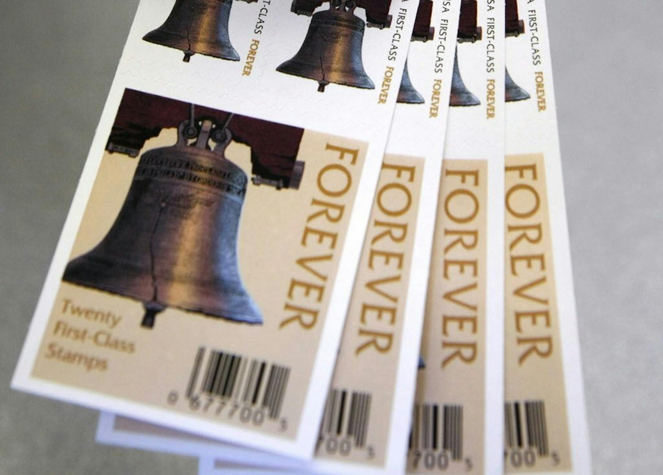 File photo, a US Postal Service employee displays Forever stamps at the main post office,