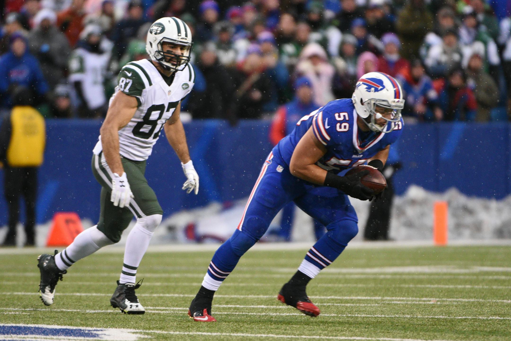New York Jets wide receiver Eric Decker (87) chases Buffalo Bills' A.J. Tarpley (59) after Tarpley intercepted a pass to end the game during the second half of an NFL football game Sunday, Jan. 3, 2016, in Orchard Park, N.Y. The Bills won 22-17. (AP Photo/Gary Wiepert)
