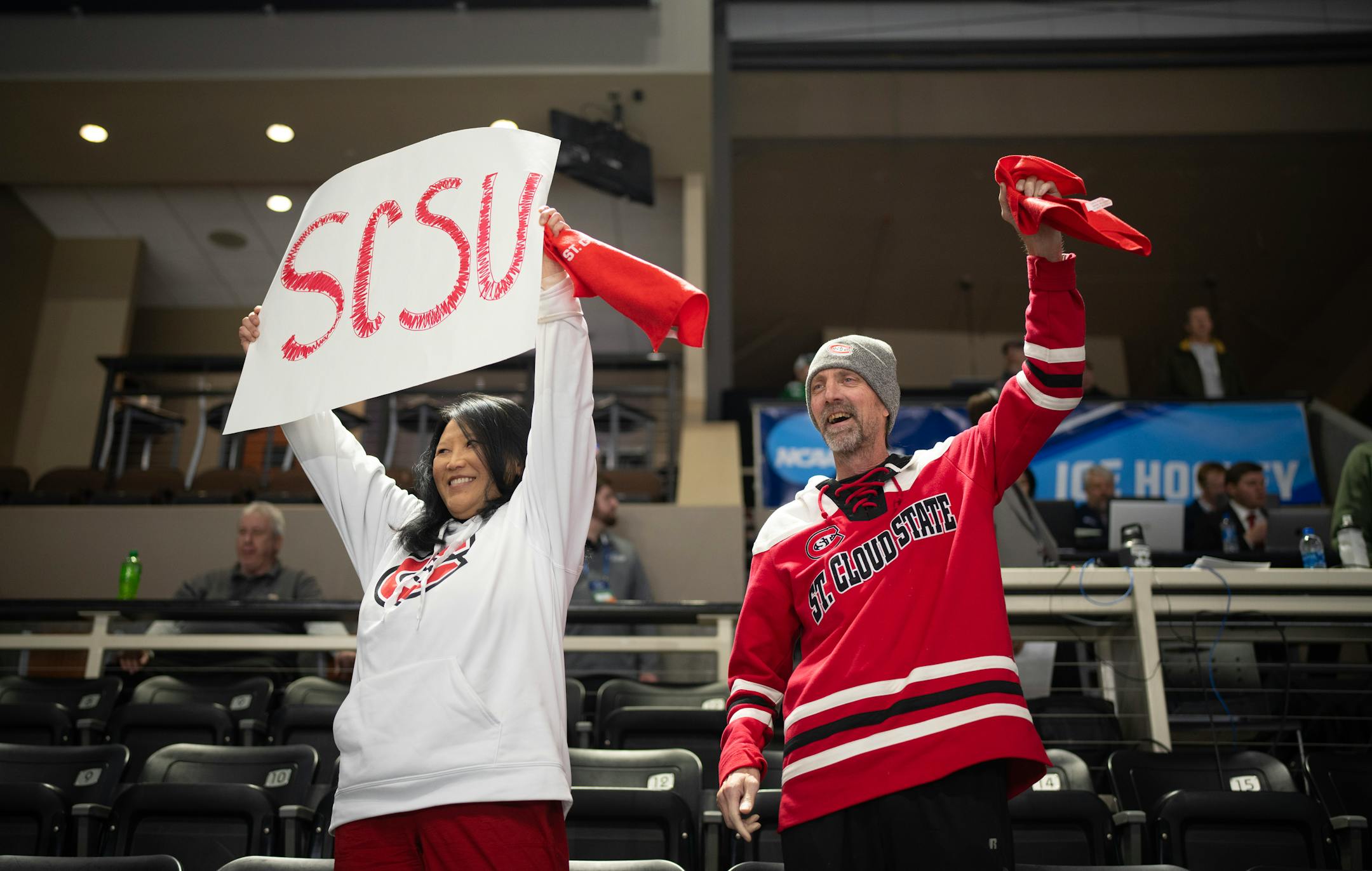 Pagnia Vang and Mark Howley, of St. Cloud, cheered as the Huskies took the ice for to warm up before their game against Minnesota State Mankato.