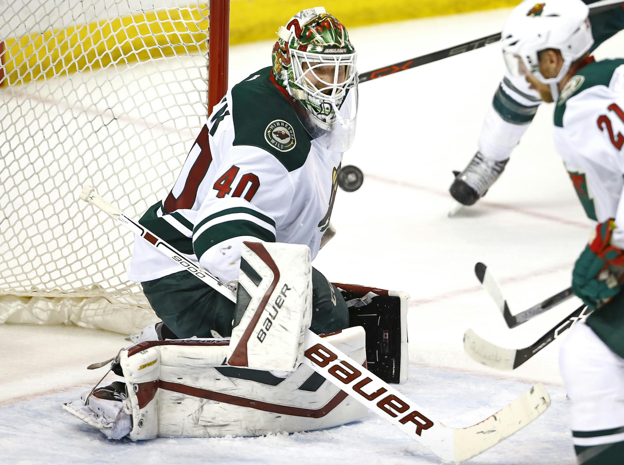 Minnesota Wild goalie Devan Dubnyk blocks a shot during the third period of an NHL hockey game against the St. Louis Blues, Saturday, March 14, 2015, in St. Louis. Minnesota won the game 3-1. (AP Photo/Billy Hurst)