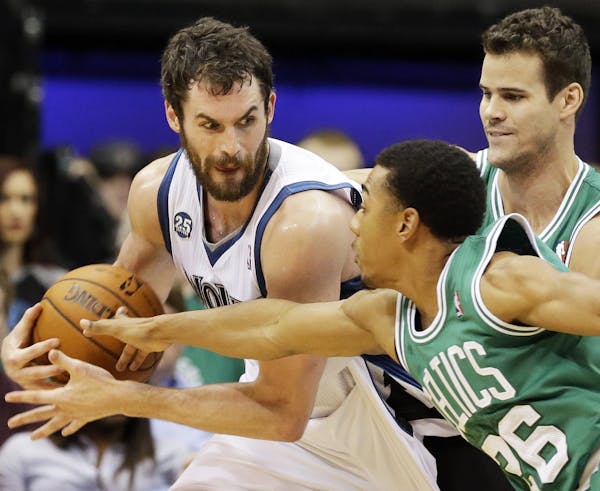 The Timberwolves' Kevin Love kept an eye on Boston's Phil Pressey, right, as Celtics' Kris Humphries came into the play in the second half Saturday.