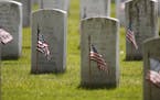 American flags have been placed by members of the 3rd U.S. Infantry Regiment, also known as The Old Guard, in front of each headstone for "Flags-In" a