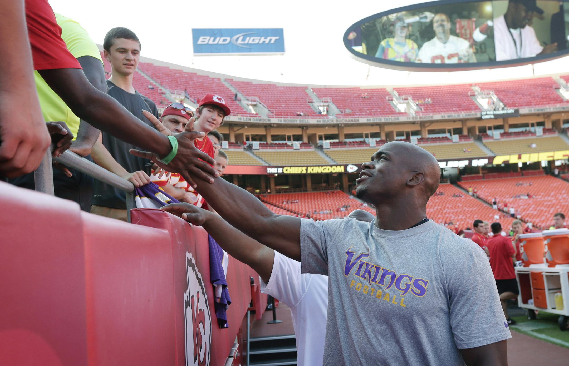 Minnesota Vikings running back Adrian Peterson greets fans before an NFL preseason football game against the Kansas City Chiefs in Kansas City, Mo., Saturday, Aug. 23, 2014. (AP Photo/Charlie Riedel)
