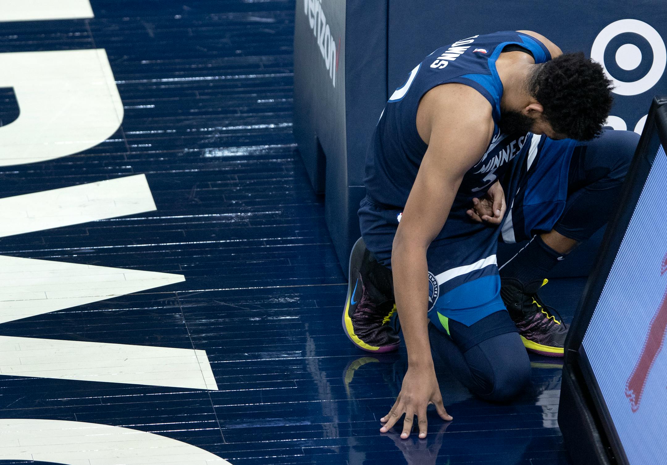 Karl-Anthony Towns (32) of the Minnesota Timberwolves bent over in pain after being fouled in the first quarter.