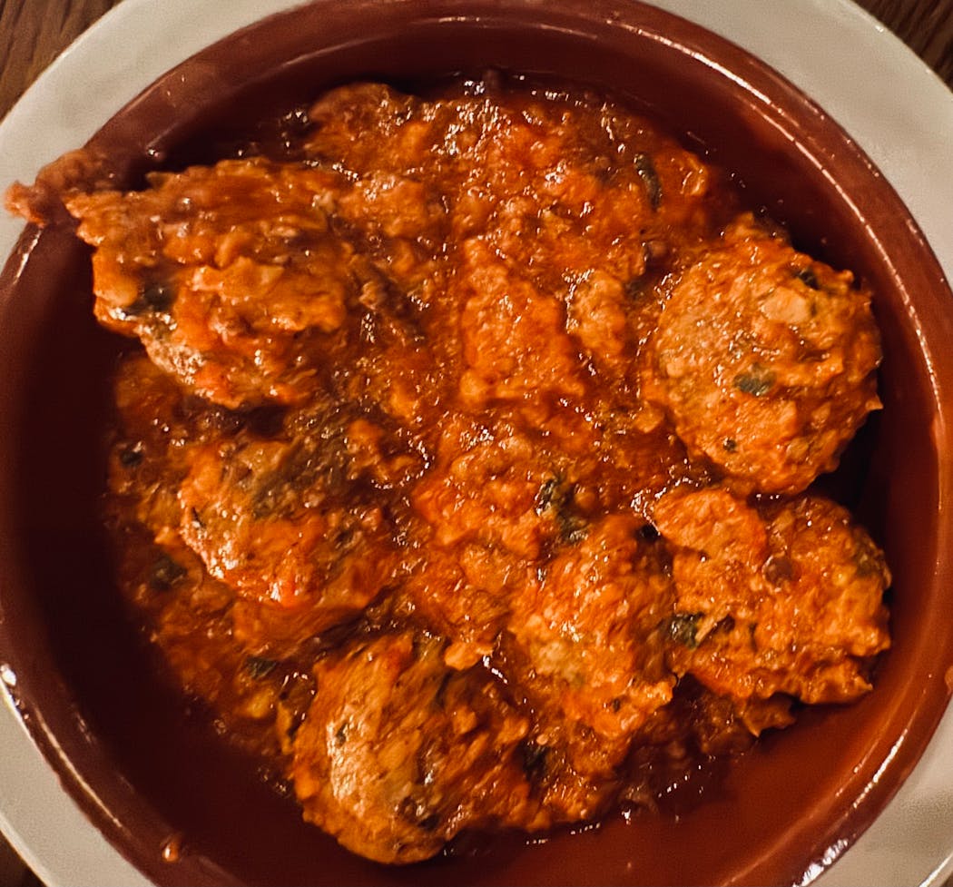 The Albondigas spiced meatballs in jamon-tomato sauce at Barcelona wine bar in Denver.