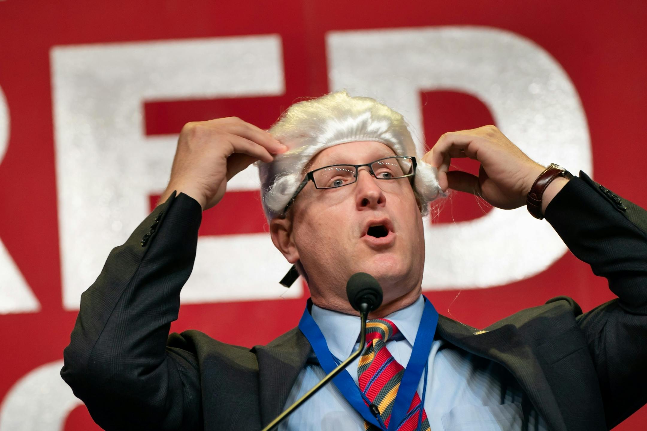 Goofing on the formality of his state Senate colleagues, convention co-chair Rep. Jim Nash donned a formal Senate wig to contrast it with the free-wheeling nature of the House.