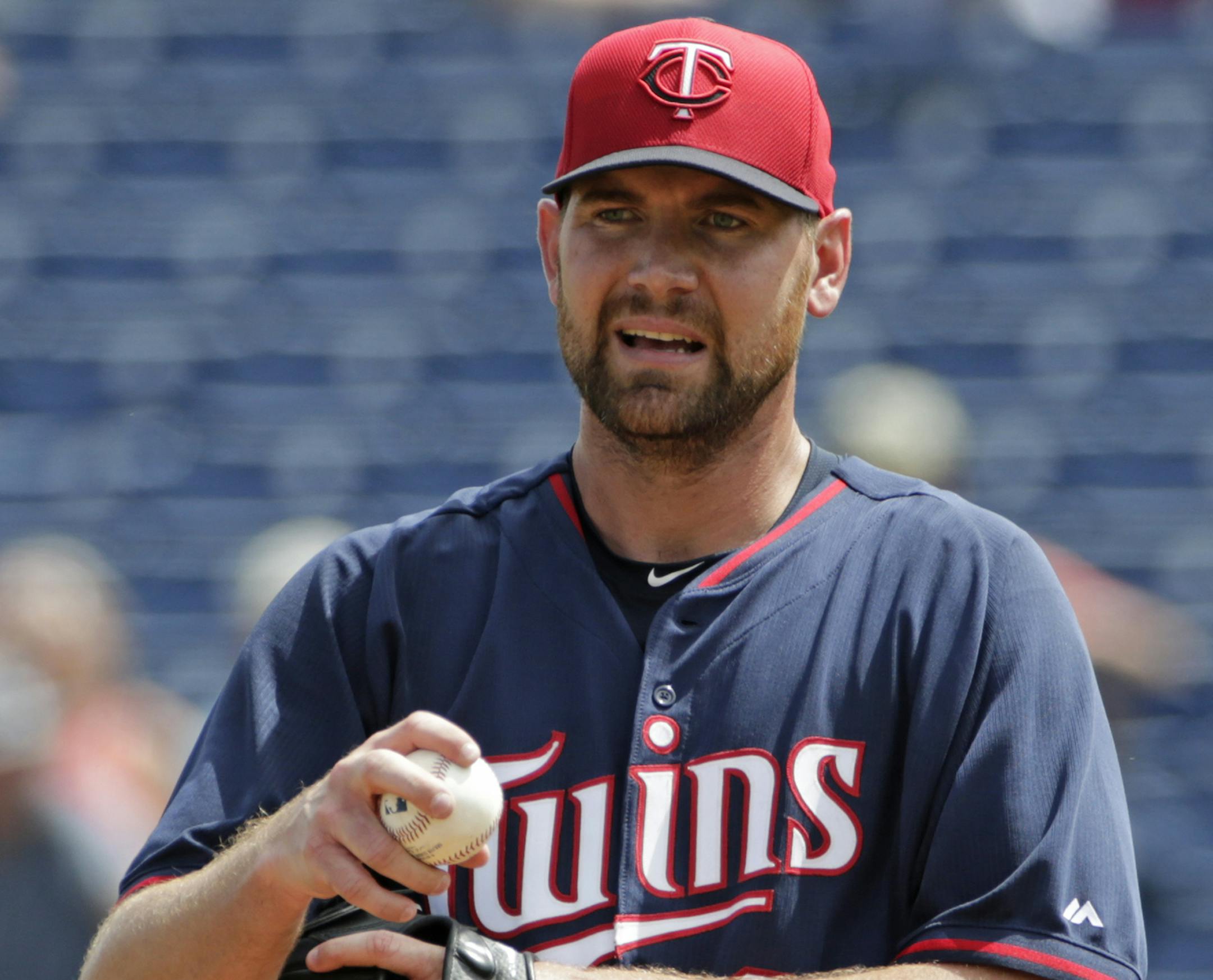 Minnesota Twins starting pitcher Mike Pelfrey pauses on the mound in the second inning of a spring training baseball game in Clearwater, Fla., Monday, March 23, 2015. (AP Photo/Kathy Willens)