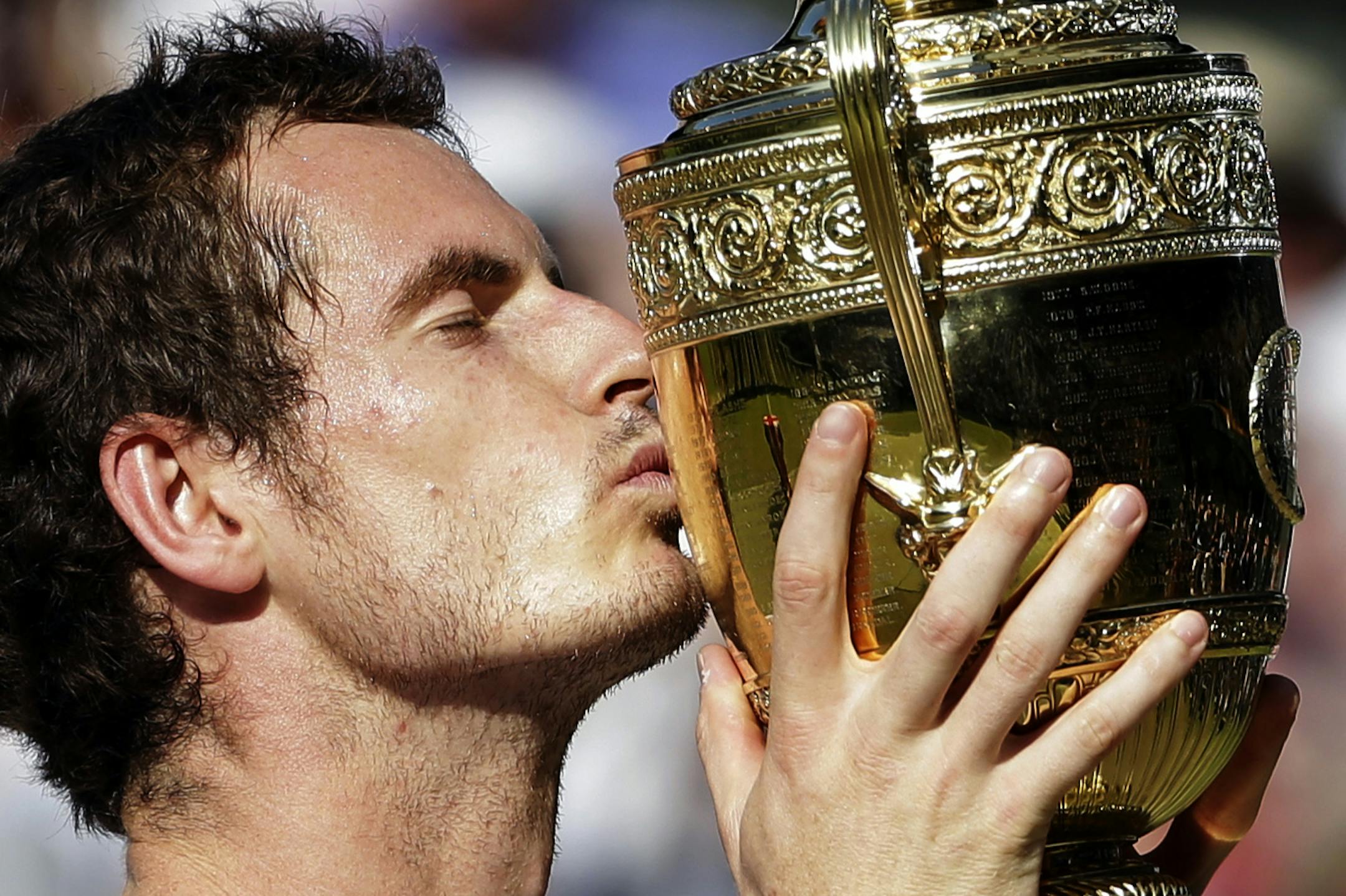 ADVANCE FOR WEEKEND EDITIONS, JUNE 21-22 - FILE - In this July 7, 2013, file photo, Andy Murray, of Britain, kisses the trophy as he poses for photographers after defeating Novak Djokovic, of Serbia, in the men's singles final at the All England Lawn Tennis Championships in Wimbledon, London. (AP Photo/Anja Niedringhaus, File)
