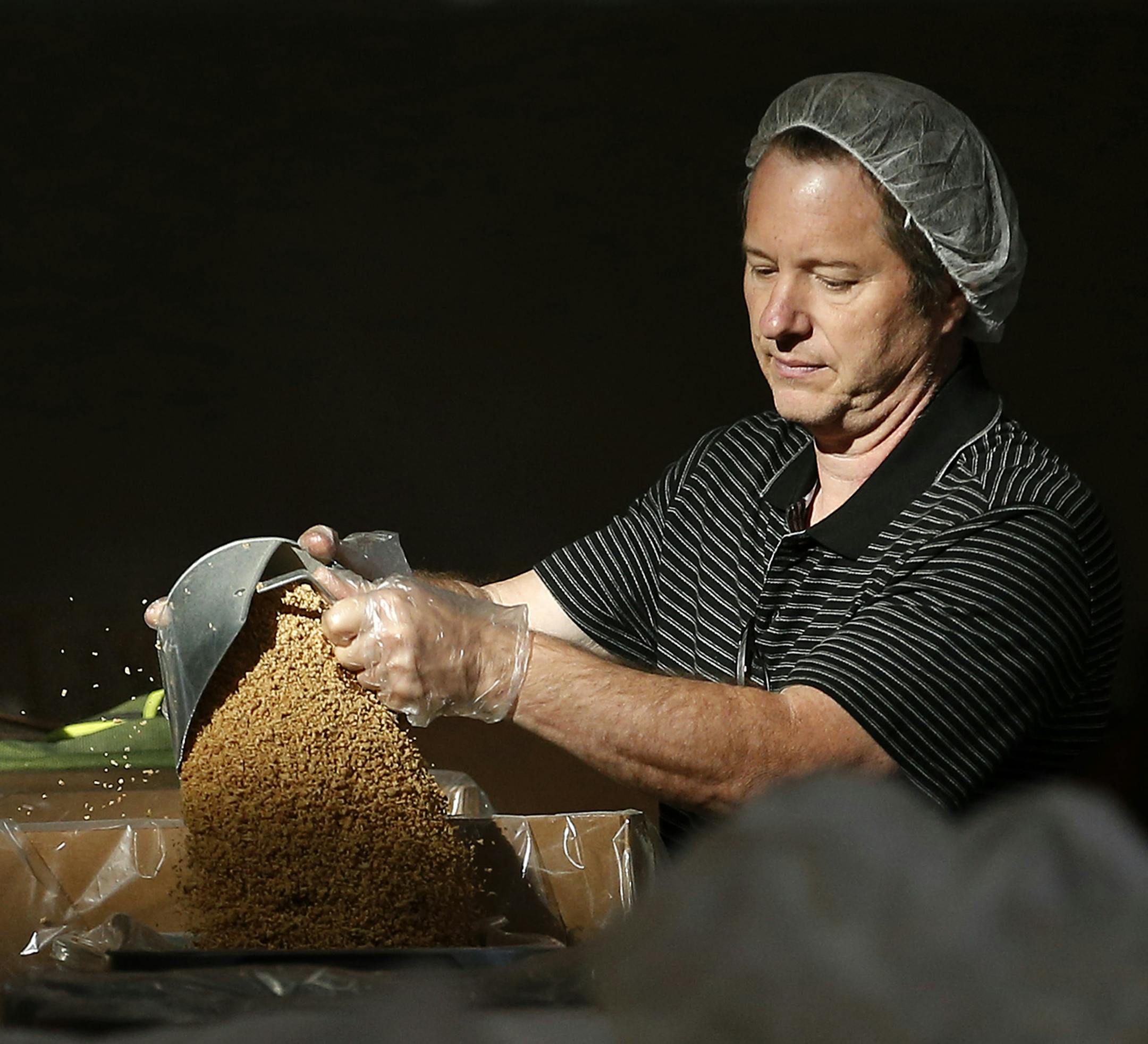 Volunteer Josh Stone of Inver Grove Heights helped prepare a meal for Feed My Starving Children at the Bielenberg Sports Center in Woodbury on Thursday. ] CARLOS GONZALEZ cgonzalez@startribune.com - October 8, 2015, Woodbury, MN, Bielenberg Sports Center, Volunteers will be working in shifts to pack meals for starving children in Africa. Feed My Starving Children is a Christian nonprofit organization.
