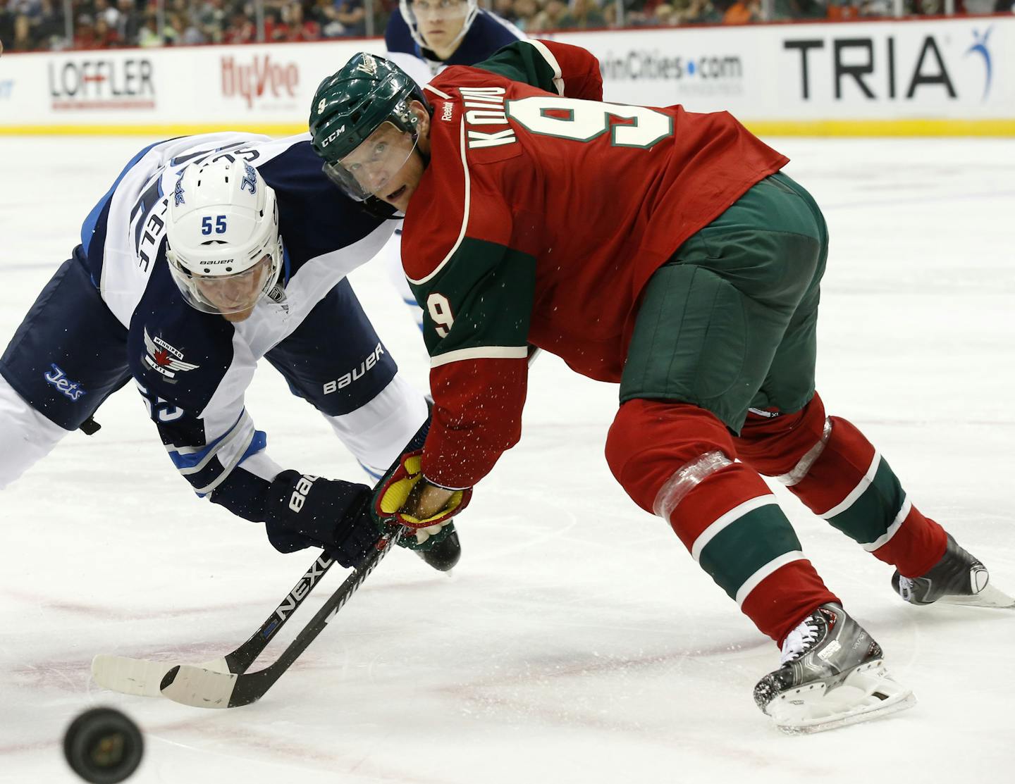 Minnesota Wild center Mikko Koivu (9), of Finland, wins a face-off against Winnipeg Jets center Mark Scheifele (55) during the second period of an NHL preseason hockey game in St. Paul, Minn., Sunday, Sept. 27, 2015. (AP Photo/Ann Heisenfelt)