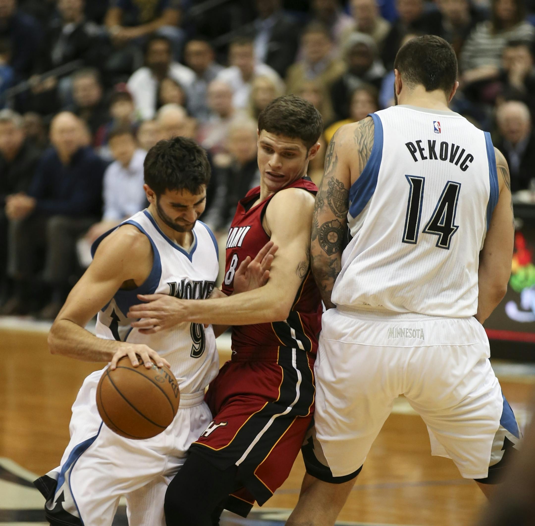 Timberwolves guard Ricky Rubio tried to squeeze past Miami Heat guard Tyler Johnson, who was up against Timberwolves center Nikola Pekovic in the second quarter Wednesday night at Target Center.
